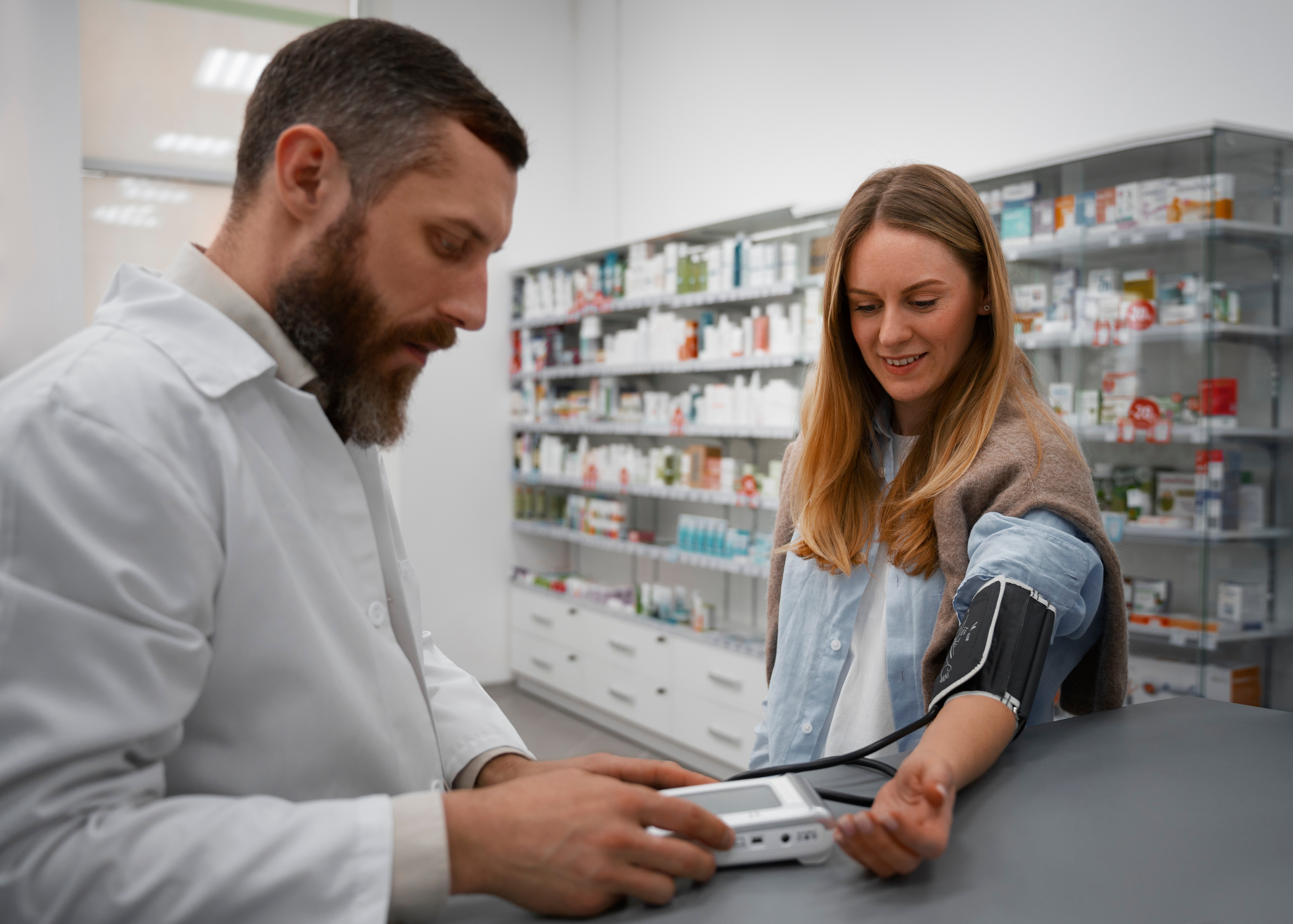 male-pharmacist-checking-woman-s-blood-pressure-1