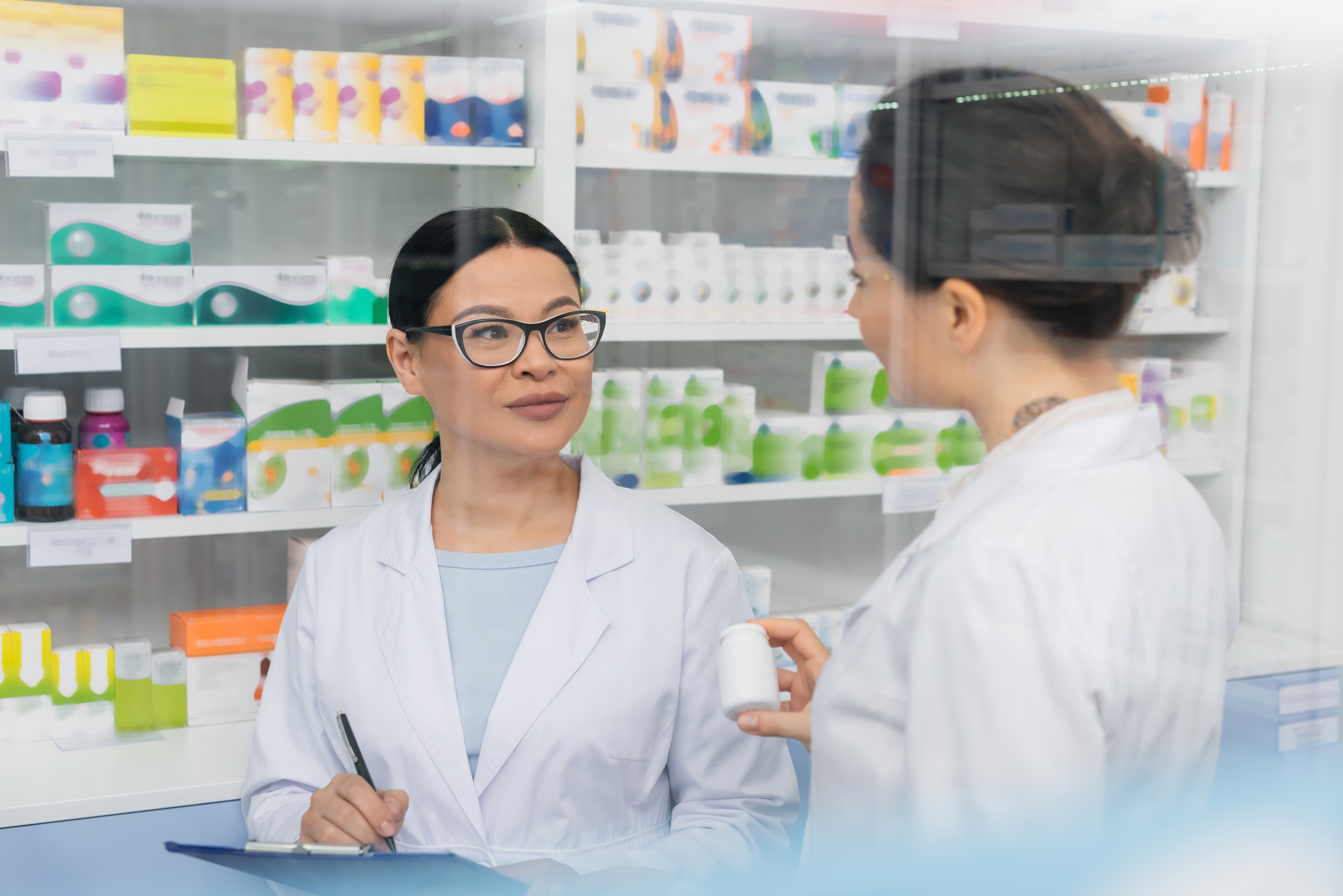 tattooed-pharmacist-in-white-coat-holding-bottle-n-2023-11-27-05-20-20-utc